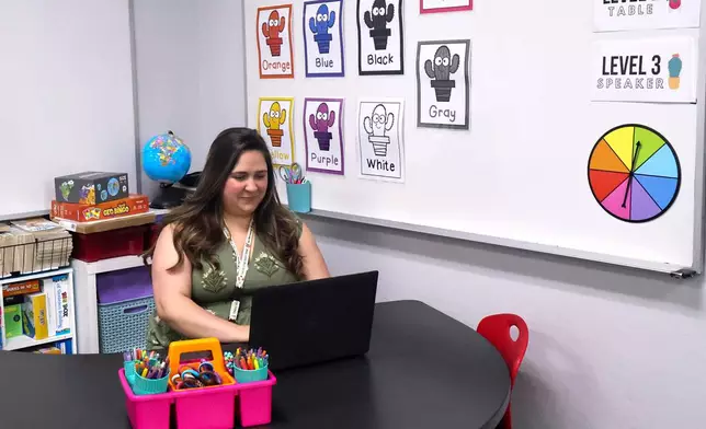 Emily Henderson sits at her desk in her first and second grade classroom ahead of the school year at BASIS Flagstaff on Thursday, Aug. 6, 2026, in Flagstaff, Ariz. (AP Photo/Cheyanne Mumphrey)