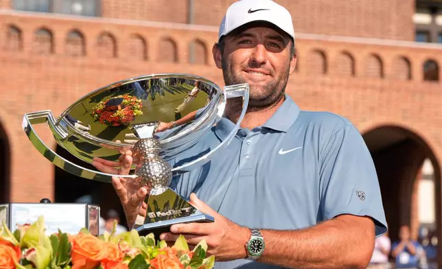 Scottie Scheffler holds the trophy after winning the PGA Tour Championship golf tournament Sunday, Aug. 30, 2026, in Atlanta. (AP Photo/Mike Stewart)