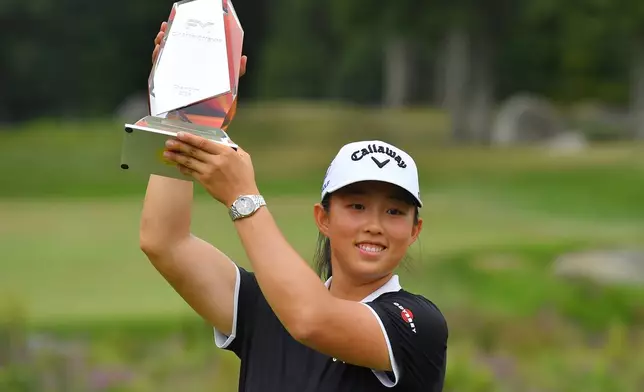 Ruoning Yin, of China, displays the FM Championship golf tournament trophy following her win in the LPGA event, Sunday, Aug. 30, 2026, in Norton, Mass. (AP Photo/Steven Senne)