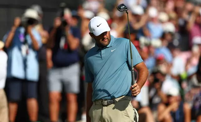 Scottie Scheffler putts on the18th green during the final round of the PGA Tour Championship golf tournament Sunday, Aug. 30, 2026, in Atlanta. (AP Photo/Colin Hubbard)