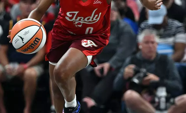 Indiana Fever guard Kelsey Mitchell (0) dribbles the ball down court during the first half of a WNBA basketball game against the Connecticut Sun, Friday, Aug. 28, 2026, in Indianapolis. (AP Photo/Marc Lebryk)