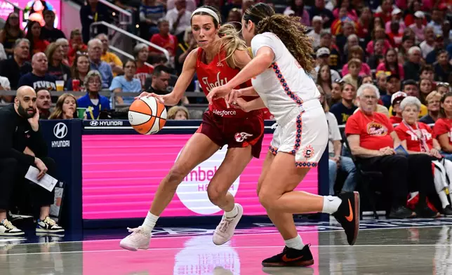 Indiana Fever guard Lexie Hull (10) dribbles the ball against Connecticut Sun guard Charlisse Leger-Walker (4) during the first half of an WNBA basketball game, Friday, Aug. 28, 2026, in Indianapolis. (AP Photo/Marc Lebryk)