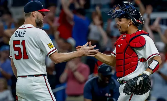 Atlanta Braves pitcher Chris Sale (51) celebrates with catcher Drake Baldwin after Sale won a complete game shutout of the Los Angeles Dodgers during the ninth inning of a baseball game, Thursday, Aug. 27, 2026, in Atlanta. (AP Photo/Erik S. Lesser)
