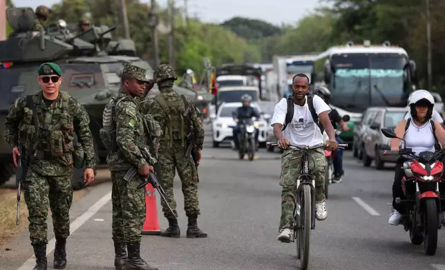 Soldiers stand guard along a road ahead of the inauguration of President-elect Abelardo de la Espriella in Cali, Colombia, Wednesday, Aug. 5, 2026. (AP Photo/Santiago Saldarriaga)