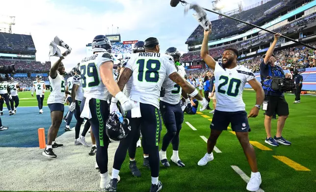 Seattle Seahawks tight end Elijah Arroyo (18) celebrates with teammates after catching a touchdown pass during the first half of a preseason NFL football game against the Tennessee Titans, Sunday, Aug. 23, 2026, in Nashville, Tenn. (AP Photo/John Amis)