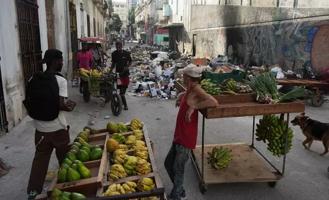 A man sells fruit during a power outage in Havana, Cuba, Monday, Aug. 3, 2026. (AP Photo/Ramon Espinosa)