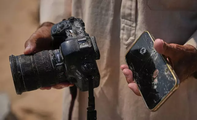 Riyad Abu Dagga, 69, displays the camera and phone belonging to his slain daughter, Mariam Dagga, a freelance journalist who worked with The Associated Press and other news outlets during the Gaza war and was killed in an Israeli airstrike on the Nasser Hospital building in Khan Younis on Aug. 25, 2025, in Khan Younis, Gaza Strip, Aug. 16, 2026. (AP Photo/Abdel Kareem Hana)