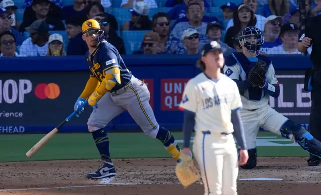 Milwaukee Brewers' William Contreras, left, heads to first for a two-run home run as Los Angeles Dodgers starting pitcher Justin Wrobleski, center, and catcher Hunter Feduccia watch during the fourth inning of a baseball game Saturday, Aug. 15, 2026, in Los Angeles. (AP Photo/Mark J. Terrill)