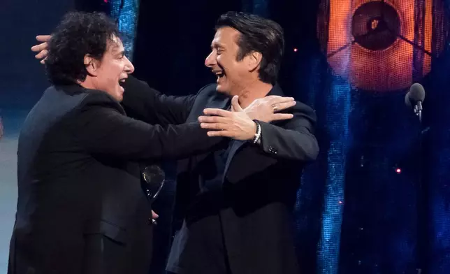 Inductees Neal Schon, left, and Steve Perry, from the band Journey, embrace at the 2017 Rock and Roll Hall of Fame induction ceremony on April 7, 2017, in New York. (Photo by Charles Sykes/Invision/AP, File)