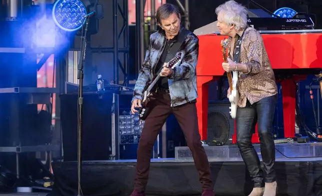 FILE - Journey guitarists Jonathan Cain, left, and Todd Jensen perform at the Cleveland Browns NFL football draft party in Cleveland, on April 24, 2025. (AP Photo/Phil Long, File)