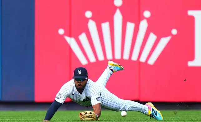 New York Yankees' Heliot Ramos drops a ball hit by Toronto Blue Jays' George Springer for a single during the seventh inning of a baseball game Saturday, Aug. 22, 2026, in New York. (AP Photo/Frank Franklin II)