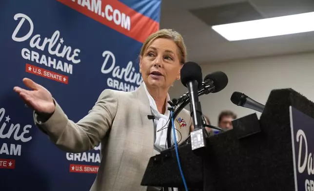 Sen. Darline Graham, R-S.C., gestures to Gov. Henry McMaster, R-S.C., at a news conference for her campaign a day ahead of the special GOP Senate runoff to replace her brother, the late Sen. Lindsey Graham, R-S.C., Monday, Aug. 24, 2026, in Columbia, S.C. (AP Photo/Meg Kinnard)