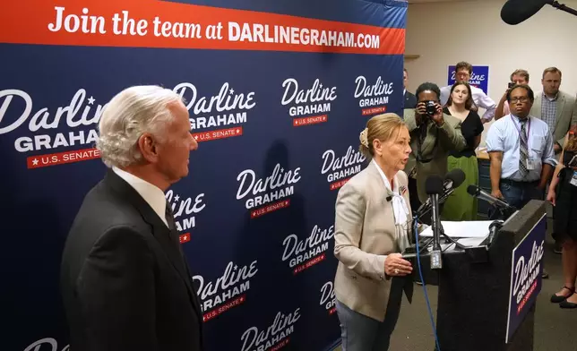 Gov. Henry McMaster, R-S.C., left, looks on as Sen. Darline Graham, R-S.C., speaks at a news conference for her campaign a day ahead of the special GOP Senate runoff to replace her brother, the late Sen. Lindsey Graham, R-S.C., Monday, Aug. 24, 2026, in Columbia, S.C. (AP Photo/Meg Kinnard)