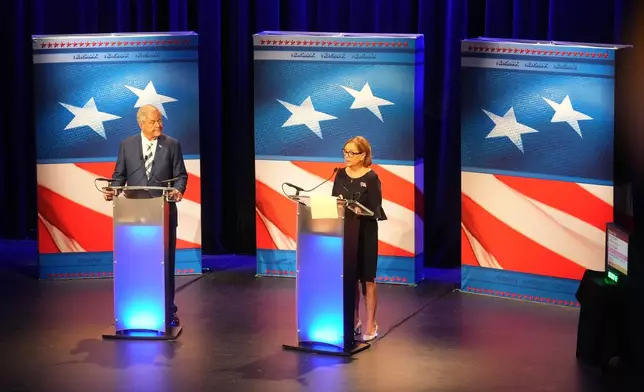 U.S. Rep. Ralph Norman, R-S.C., left, looks on as Sen. Darline Graham, R-S.C., speaks during a special GOP Senate runoff debate to replace the late Sen. Lindsey Graham, R-S.C., on Tuesday, Aug. 18, 2026, in Newberry, S.C. (AP Photo/Meg Kinnard)