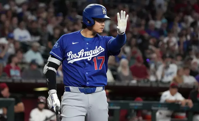 Los Angeles Dodgers' Shohei Ohtani reacts after hitting the ball against the Arizona Diamondbacks in the first inning of a baseball game, Sunday, Aug 9, 2026, in Phoenix. (AP Photo/Rick Scuteri)