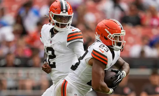 Cleveland Browns quarterback Shedeur Sanders (2) hands off to running back Ahmani Marshall (23) during the first half of an NFL preseason football game against the Buffalo Bills, Saturday, Aug. 22, 2026, in Cleveland. (AP Photo/Carolyn Kaster)