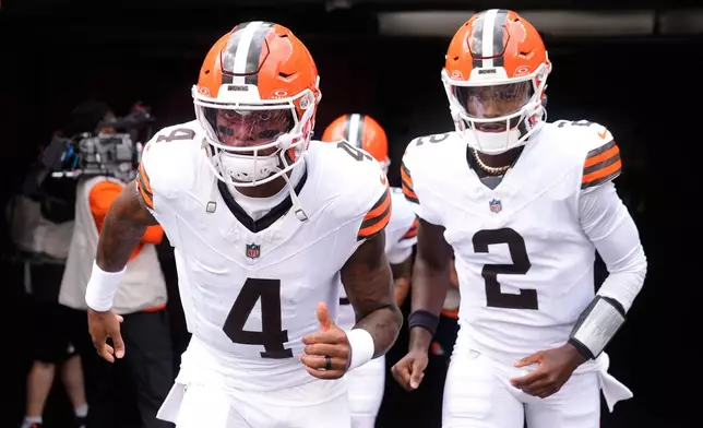 Cleveland Browns quarterback Deshaun Watson (4) and quarterback Shedeur Sanders (2) enter the field to warm up before a preseason NFL football game against the Buffalo Bills, Saturday, Aug. 22, 2026, in Cleveland. (AP Photo/Carolyn Kaster)