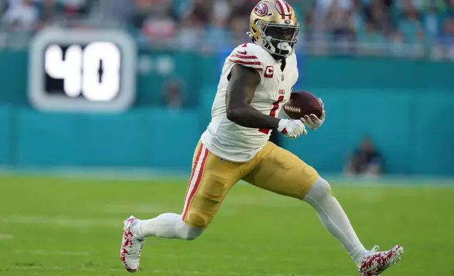 FILE - San Francisco 49ers wide receiver Deebo Samuel Sr. (1) runs for a first down during the first half of an NFL football game against the Miami Dolphins, Dec. 22, 2024, in Miami Gardens, Fla. (AP Photo/Lynne Sladky, File)
