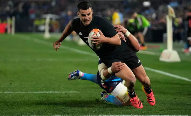New Zealand's Josh Moorby, front, breaks away from Bulls' Hanro Liebenberg, to score a try during a rugby match between Bulls and New Zealand, in Pretoria, South Africa, Saturday, Aug. 15, 2026. (AP Photo/Themba Hadebe)