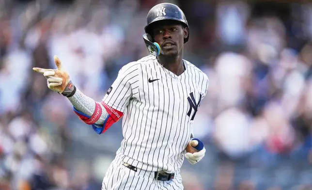 New York Yankees' Jazz Chisholm Jr. gestures to teammates after hitting a two-run home run during the seventh inning of a baseball game against the Toronto Blue Jays Sunday, Aug. 23, 2026, in New York. (AP Photo/Frank Franklin II)