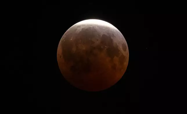 A partial lunar eclipse is seen on Friday, Aug. 28, 2026, in Cleveland. (AP Photo/Carolyn Kaster)