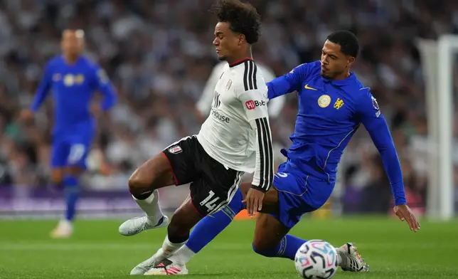 Chelsea's Jordan Henderson tackles Fulham's Oscar Bobb during the English Premier League soccer match between Fulham and Chelsea in London, Monday, Aug. 24, 2026. (AP Photo/Kirsty Wigglesworth)