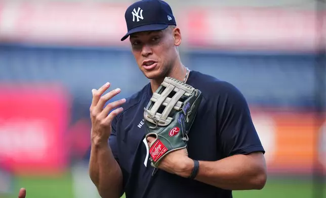 New York Yankees' Aaron Judge talks to third base/outfield coach Luis Rojas before a baseball game against the Houston Astros Tuesday, Aug. 25, 2026, in New York. (AP Photo/Frank Franklin II)