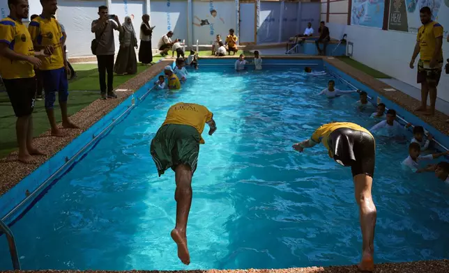 Amputee swimming trainees jump into a pool during a training session for Palestinian children who lost their legs after being injured during the war between Israel and Hamas, in Khan Younis, Gaza Strip, Wednesday, Aug. 19, 2026. (AP Photo/Abdel Kareem Hana)