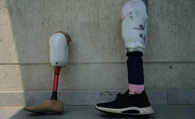 Prosthetic limbs belonging to Palestinian children who lost their legs after being injured in the war between Israel and Hamas are placed beside the pool as the children receive swimming training from the Heal Palestine organization in Khan Younis, Gaza Strip, Thursday, Aug. 20, 2026. (AP Photo/Abdel Kareem Hana)