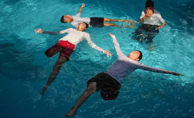 Palestinian children who lost their legs after being injured during the war between Israel and Hamas receive swimming training from the Heal Palestine organization at a pool in Khan Younis, Gaza Strip, Wednesday, Aug. 19, 2026. (AP Photo/Abdel Kareem Hana)