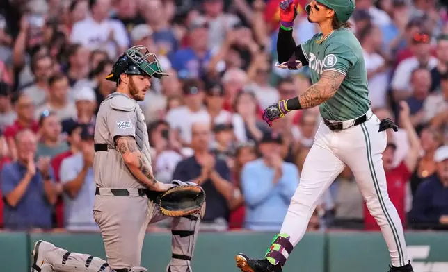 Boston Red Sox's Jarren Duran, right, celebrates after his two-run home run during the second inning of a baseball game against the Athletics, Friday, Aug. 7, 2026, in Boston. (AP Photo/Charles Krupa)