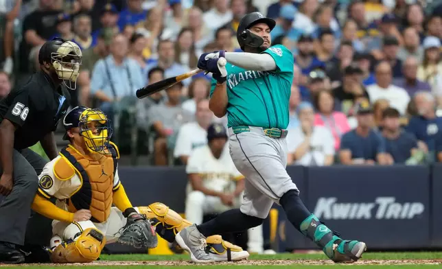Seattle Mariners' Josh Naylor hits a two-run single during the second inning of a baseball game against the Milwaukee Brewers, Wednesday, Aug. 19, 2026, in Milwaukee. (AP Photo/Aaron Gash)