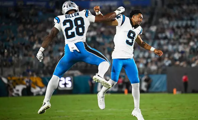 Carolina Panthers running back AJ Dillon celebrates after scoring with quarterback Bryce Young during the first half of an NFL preseason football game against the Jacksonville Jaguars, Friday, Aug. 21, 2026, in Jacksonville, Fla. (AP Photo/Phelan M. Ebenhack)
