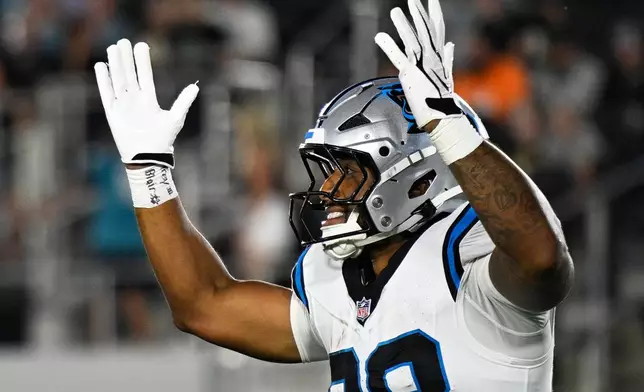 Carolina Panthers running back AJ Dillon celebrates after scoring during the first half of an NFL preseason football game against the Jacksonville Jaguars, Friday, Aug. 21, 2026, in Jacksonville, Fla. (AP Photo/Phelan M. Ebenhack)