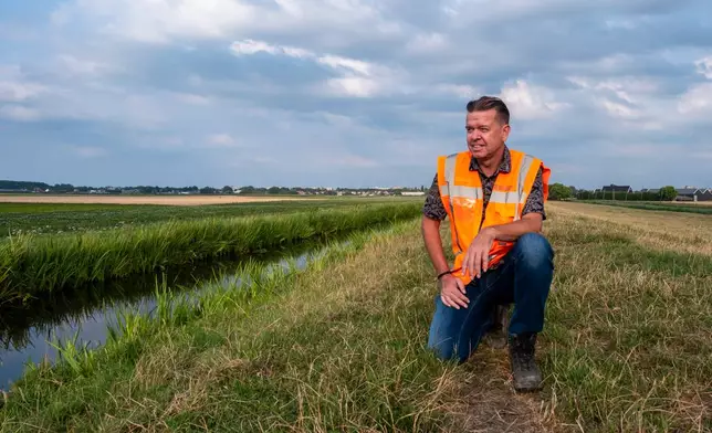 Peter van Duijvendijk, flood defense manager, poses near a dike in Waddinxveen, Netherlands, Thursday, July 30, 2026, during drought conditions. (AP Photo/Patrick Post)