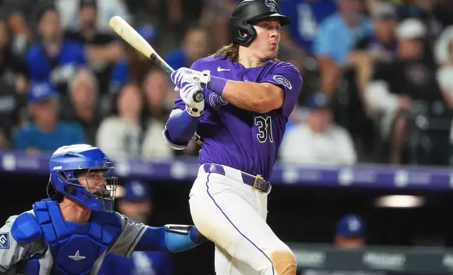Colorado Rockies' Jake McCarthy doubles off Los Angeles Dodgers relief pitcher Tanner Scott in the ninth inning of a baseball game Tuesday, Aug. 18, 2026, in Denver. (AP Photo/David Zalubowski)