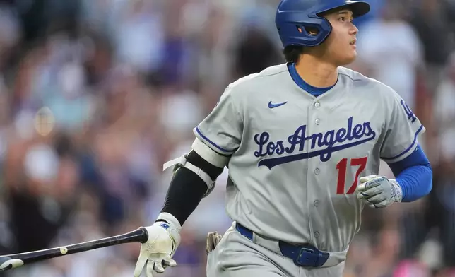 Los Angeles Dodgers' Shohei Ohtani drops his bat as he heads up the first-base line after hitting a two-run home run off Colorado Rockies starting pitcher Ryan Feltner in the third inning of a baseball game Tuesday, Aug. 18, 2026, in Denver. (AP Photo/David Zalubowski)