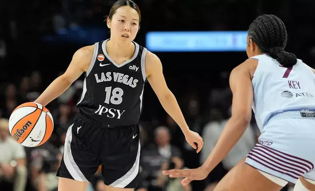 Las Vegas Aces guard Mai Yamamoto (18) drives against Toronto Tempo forward Teonni Key (7) during the second half of a WNBA basketball game Friday, Aug. 28, 2026, in Las Vegas. (AP Photo/John Locher)