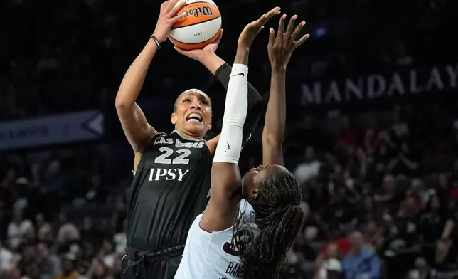 Las Vegas Aces center A'ja Wilson (22) shoots over Toronto Tempo guard Ornella Bankole (33) during the second half of a WNBA basketball game Friday, Aug. 28, 2026, in Las Vegas. (AP Photo/John Locher)