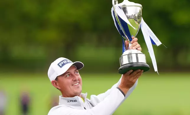 Winner Joe Dean of England celebrates with the trophy on day four of the British Masters at The Belfry Hotel & Resort, Sutton Coldfield, England, Sunday Aug. 30, 2026. (Bradley Collyer/PA via AP)