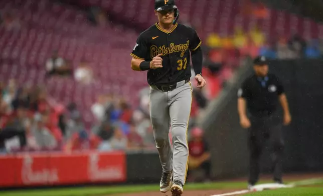 Pittsburgh Pirates' Henry Davis scores after a bases loaded walk is drawn by Bryan Reynolds during the third inning of a baseball game against the Cincinnati Reds in Cincinnati, Saturday, Aug. 1, 2026. (AP Photo/Tanner Pearson)