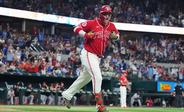 Texas Rangers designated hitter Joc Pederson celebrates after his two-run home run that also scored Elias Díaz during the sixth inning of a baseball game against the Baltimore Orioles, Friday, Aug. 7, 2026, in Arlington, Texas. (AP Photo/LM Otero)