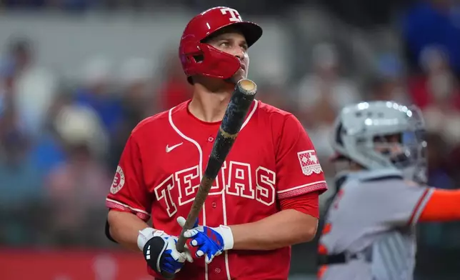 Texas Rangers' Corey Seager heads to the dugout after striking out swinging during the fourth inning of a baseball game against the Baltimore Orioles, Friday, Aug. 7, 2026, in Arlington, Texas. (AP Photo/LM Otero)
