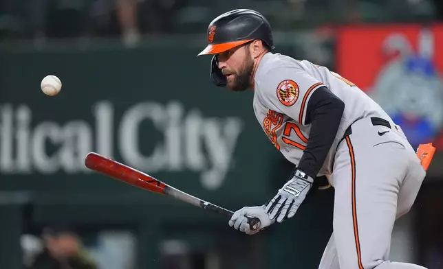 Baltimore Orioles' Colton Cowser runs as he looks at his soft grounder infield out during the second inning of a baseball game against the Texas Rangers, Friday, Aug. 7, 2026, in Arlington, Texas. (AP Photo/LM Otero)