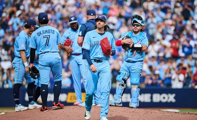 Toronto Blue Jays' Kevin Gausman (34) looks on as he is taken out of the game by manager John Schneider during sixth inning MLB baseball action against the St. Louis Cardinals in Toronto, on Saturday, Aug. 1, 2026. THE CANADIAN PRESS/Sammy Kogan/The Canadian Press via AP)