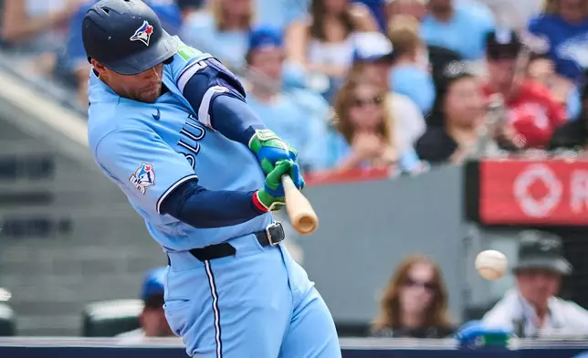 Toronto Blue Jays' George Springer hits an RBI single against the St. Louis Cardinals during the third inning of a baseball game in Toronto, Saturday, Aug. 1, 2026. (Sammy Kogan/The Canadian Press via AP)