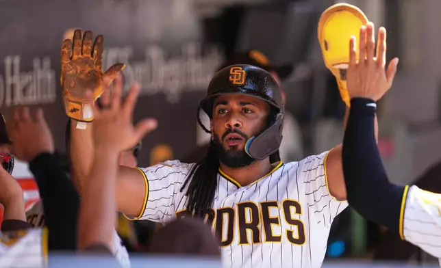 San Diego Padres' Fernando Tatis Jr. celebrates after scoring off an RBI single by Jake Cronenworth during the eighth inning of a baseball game against the Milwaukee Brewers Wednesday, Aug. 12, 2026, in San Diego. (AP Photo/Gregory Bull)