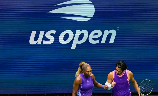 Serena Williams, of the United States, and Carlos Alcaraz, of Spain, react during a mixed doubles match at the U.S. Open tennis championships, Tuesday, Aug. 25, 2026, in New York. (AP Photo/Yuki Iwamura)