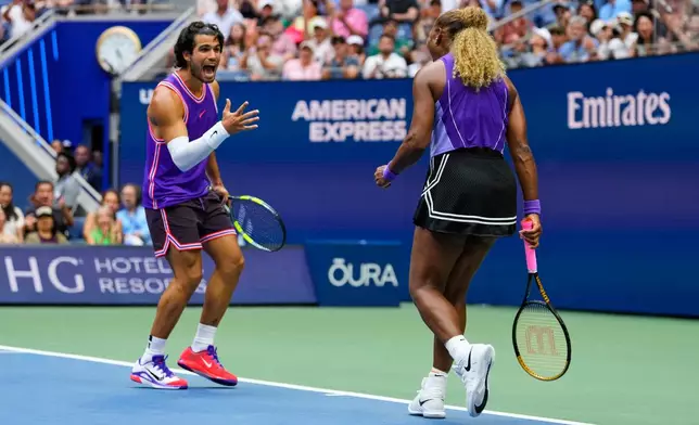 Carlos Alcaraz, of Spain, left, and Serena Williams, of the United States, react during a mixed doubles match at the U.S. Open tennis championships, Tuesday, Aug. 25, 2026, in New York. (AP Photo/Yuki Iwamura)