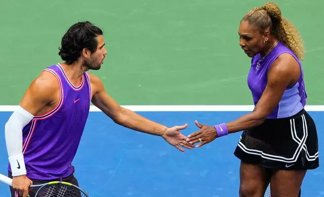 Carlos Alcaraz, of Spain, left, and Serena Williams, of the United States, high-five during a mixed doubles match at the U.S. Open tennis championships, Tuesday, Aug. 25, 2026, in New York. (AP Photo/Yuki Iwamura)